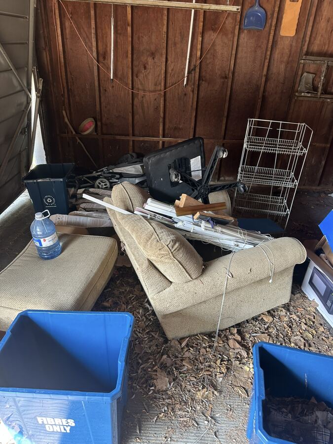 Old couch and chairs in a garage, ready for pickup